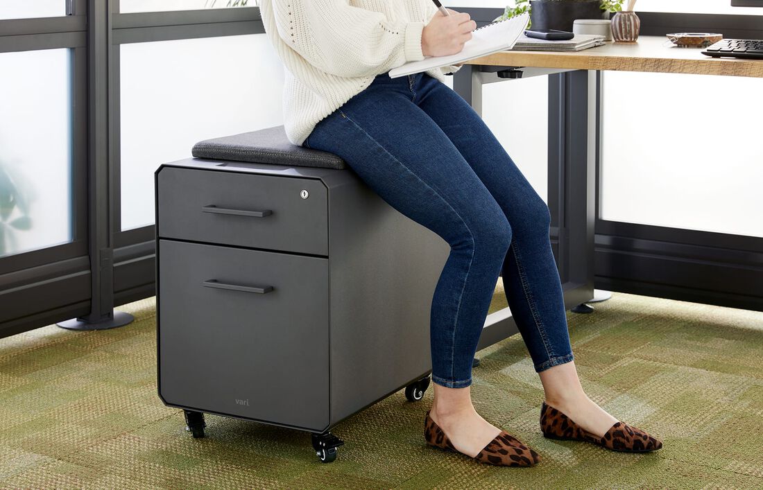 individual seated on vari storage seat