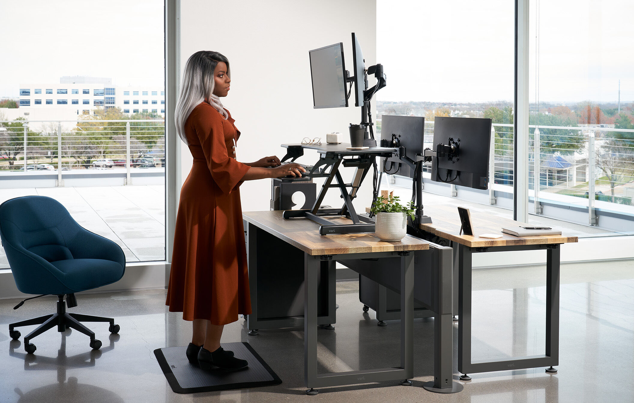 an individual standing and working at a desk converter  image