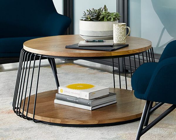 round coffee table with decor, books, and a notebook