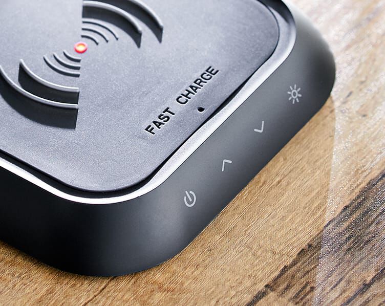 front of charging base shown, buttons for light include power onm and off, more light, less light, and color temperature changer