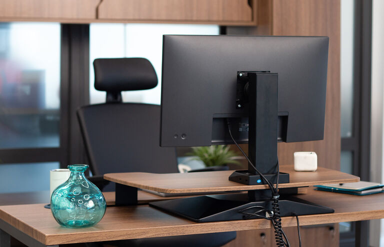 professional standing and working in front of an electric converter on top of a desk