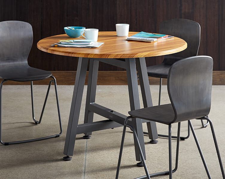 standard height table in office breakroom surrounded by three chairs