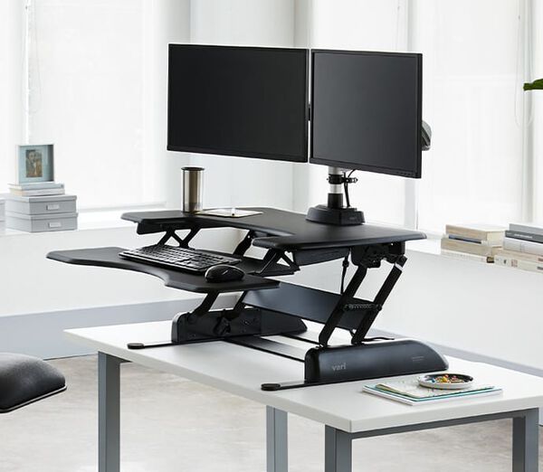 VariDesk Pro Plus in raised position on table
