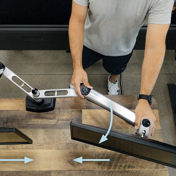 Adjusting monitor arms to level monitors