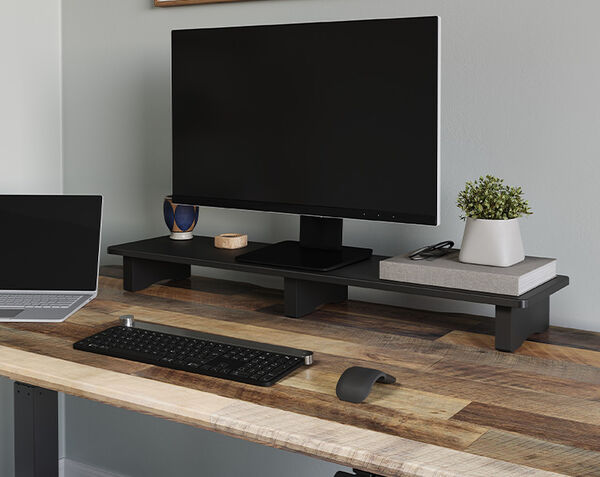 vari desk shelf setup on top of a desk holding a monitor and other accessories
