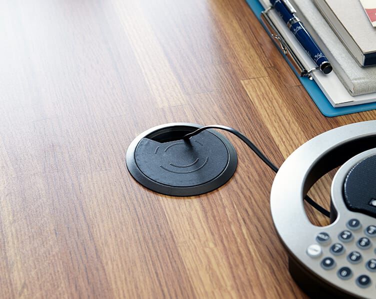cable management access point shown with cables threaded through to support the conference call equipment
