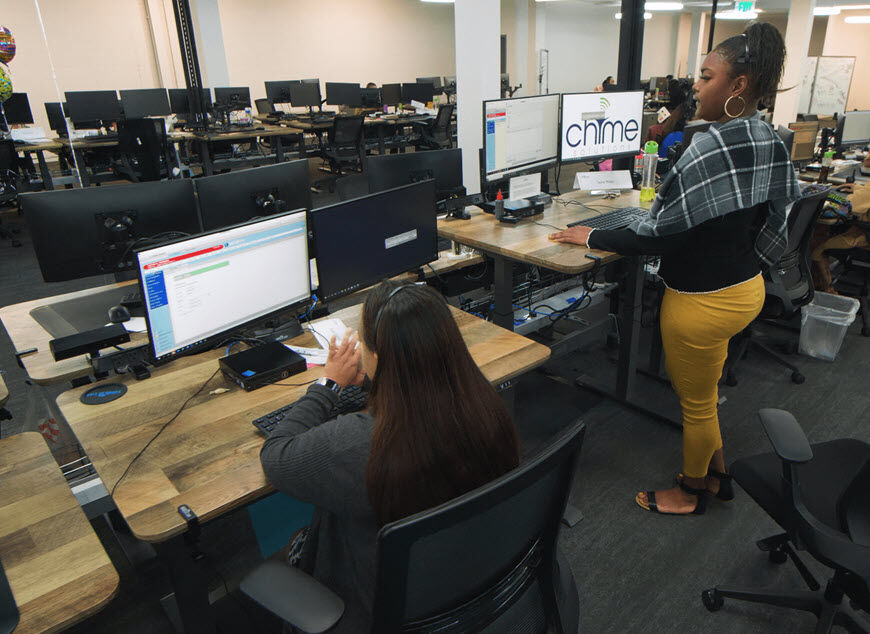 vari electric standing desks in use at Chime solutions headuarters  image