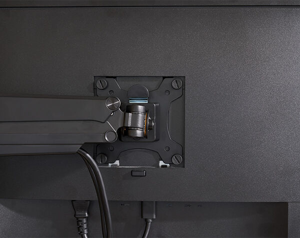 Person adjusting monitor that is mounted to monitor arm to a vertical position