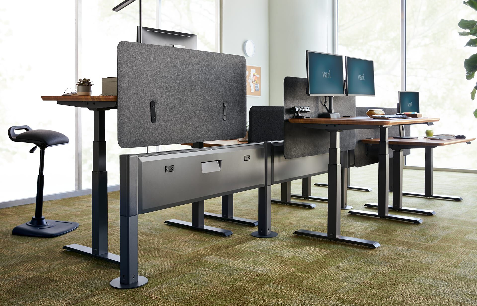 Felt Privacy+Modesty Panel 60 is seen in an open office, attached to each desk in a pack of 6, so that each desk has enhanced privacy and sound dampening