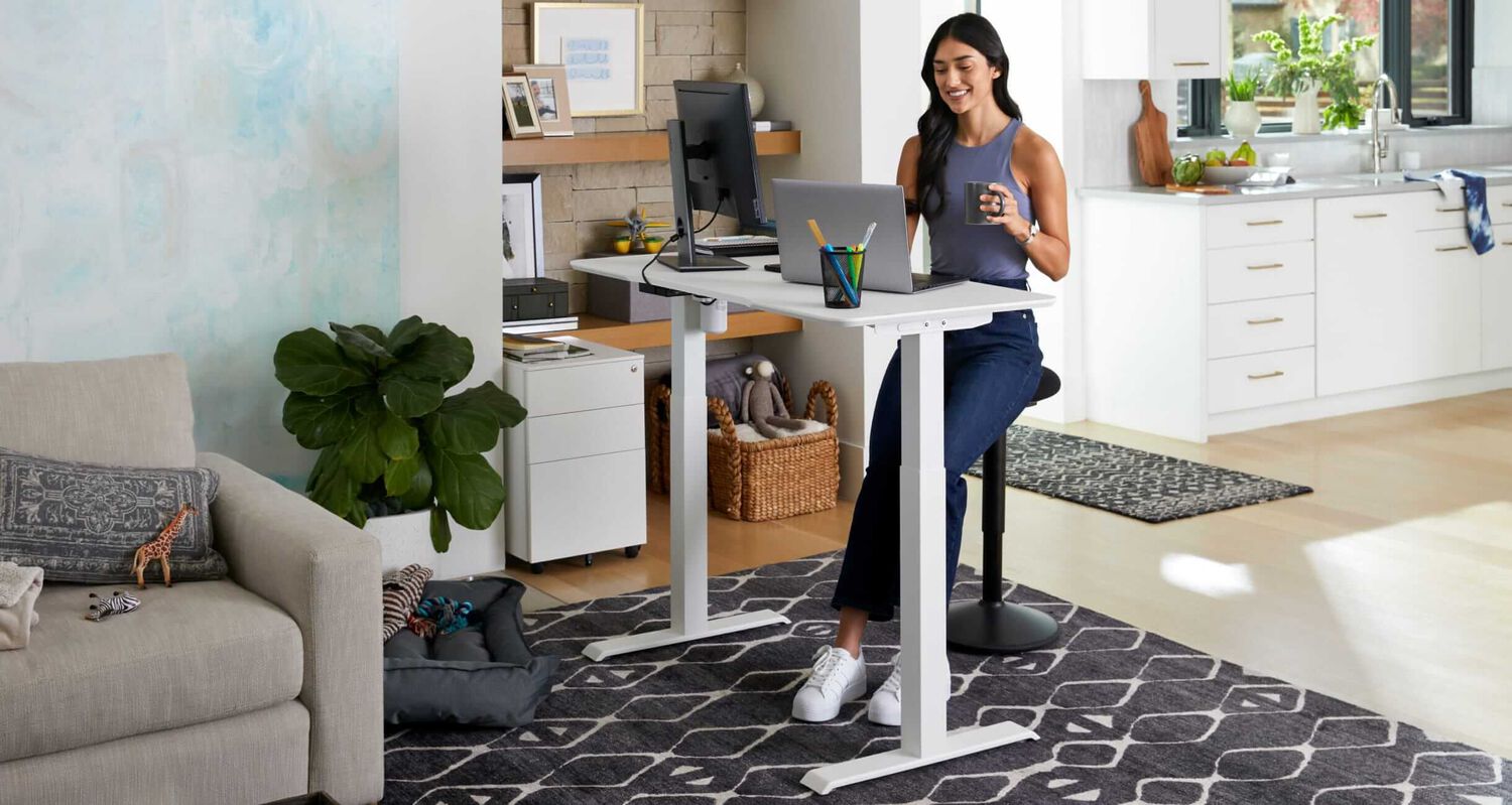 individual sitting working at a desk in a home setting