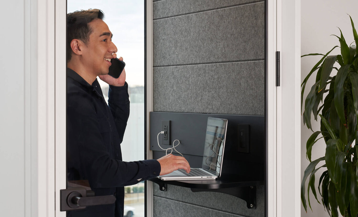 professional using the phone while inside the privacy booth