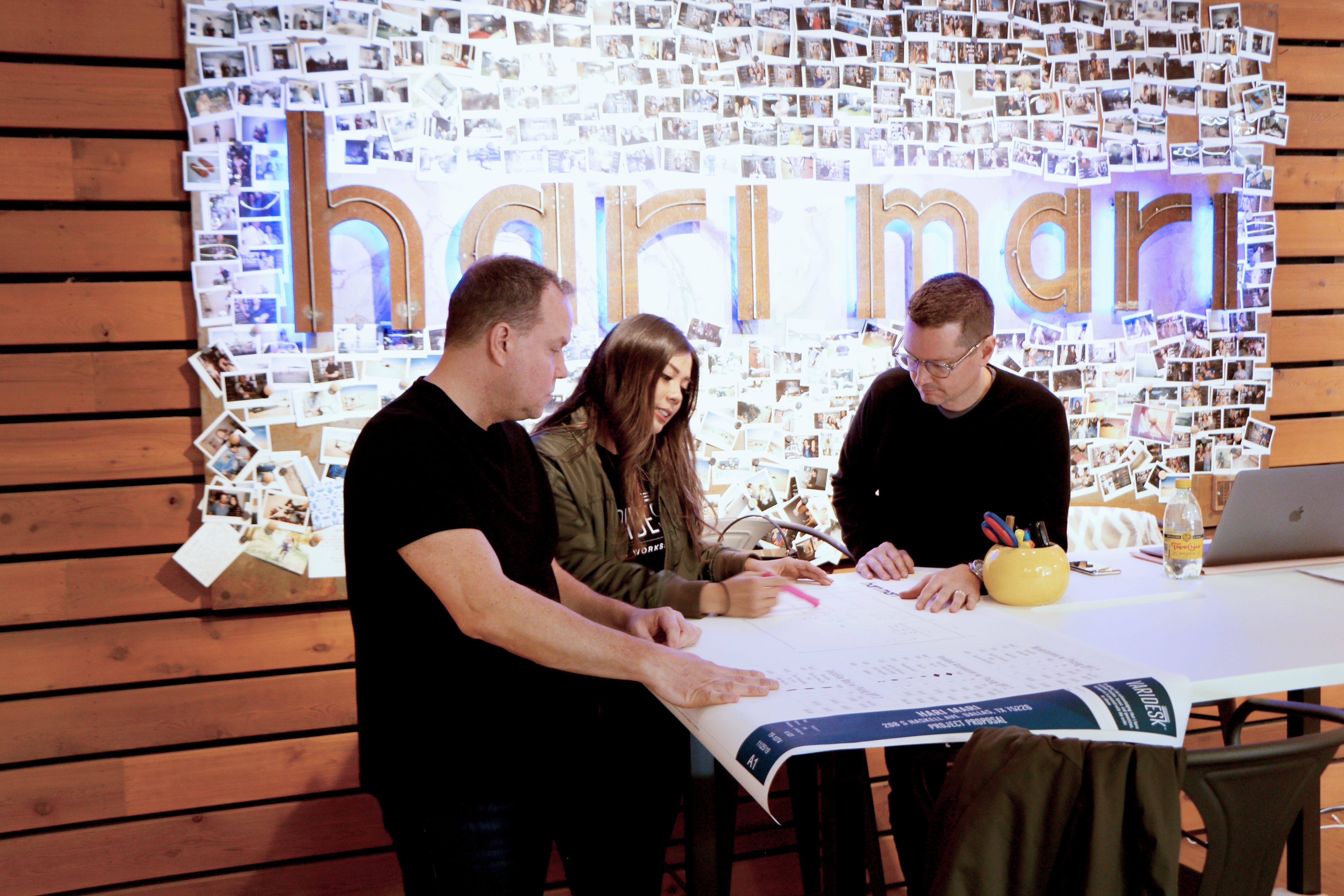 professionals collaborating at vari standing conference table in Hari Mari office  image