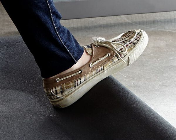 individual standing on vari active mat