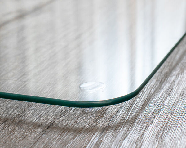 close up of the streak free glass chair mat set atop wood flooring