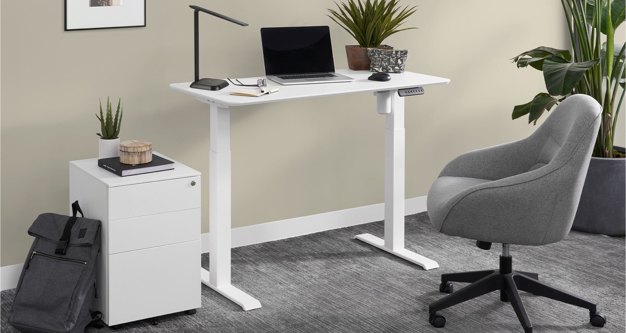 an essential electric standing desk paired with vari accessories creates a comfortable home workspace