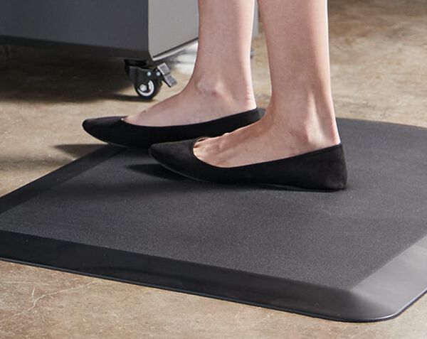 professional stands on mat and exhibits the support offered by it