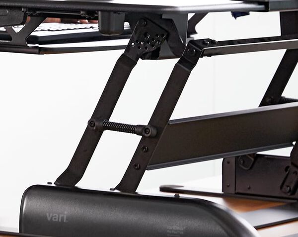 Close up of the spring-assisted lift on the desktop riser