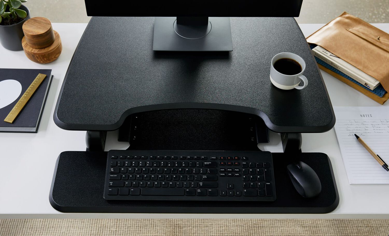 Overhead view of desk riser on static height desk in office setting