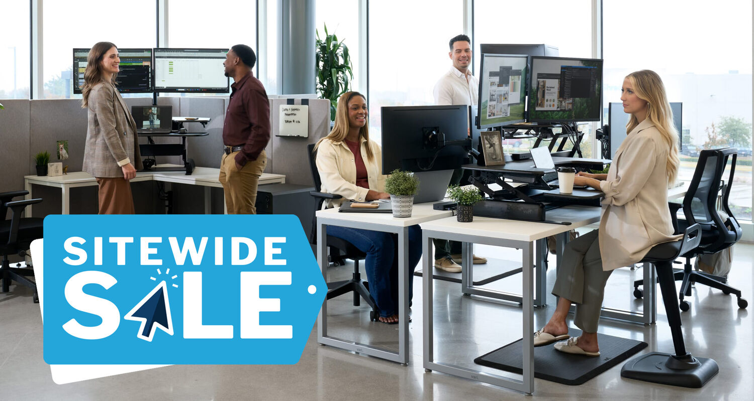 individuals working at their workspaces in an open office