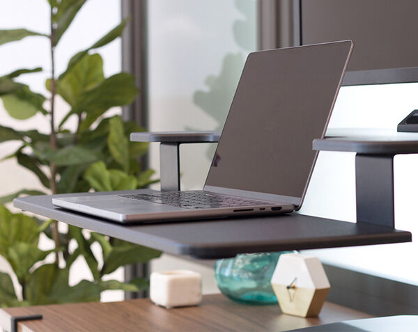close up view of varidesk premier electric keyboard stand with a tilt for laptop monitor and phone rest