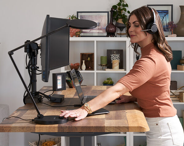 studio lamp is being turned on by a user on a comfortedge electric standing deak