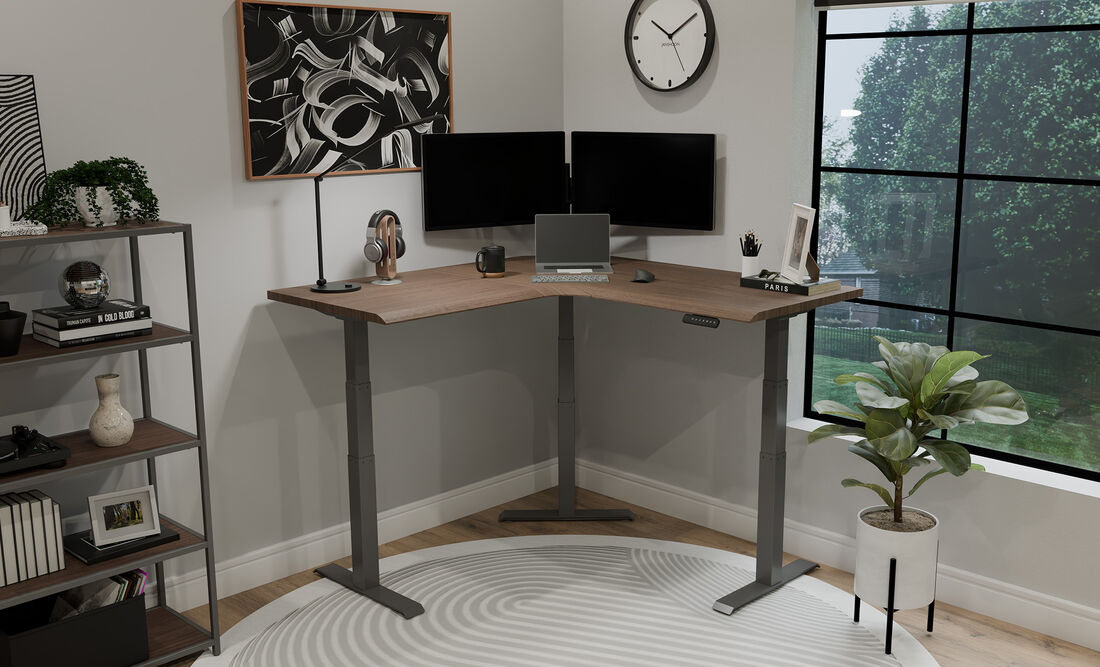 L-Shape electric standing desk setup in the corner of a home office workspace