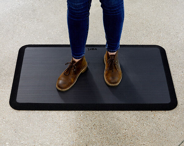 professional stands on mat and exhibits the support offered by it