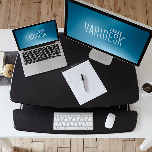 overhead view of desk converter with monitor and laptop