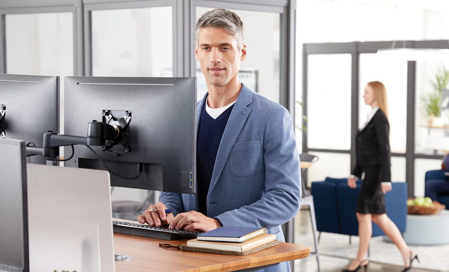 individual using desk and Vari Dual Monitor arm 180 degree