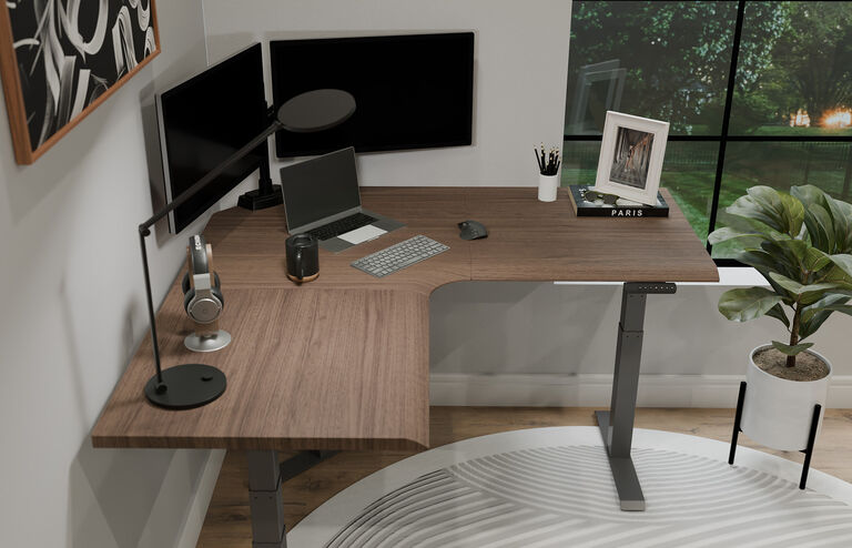 L-Shape Electric Standing Desk setup in an open workspace