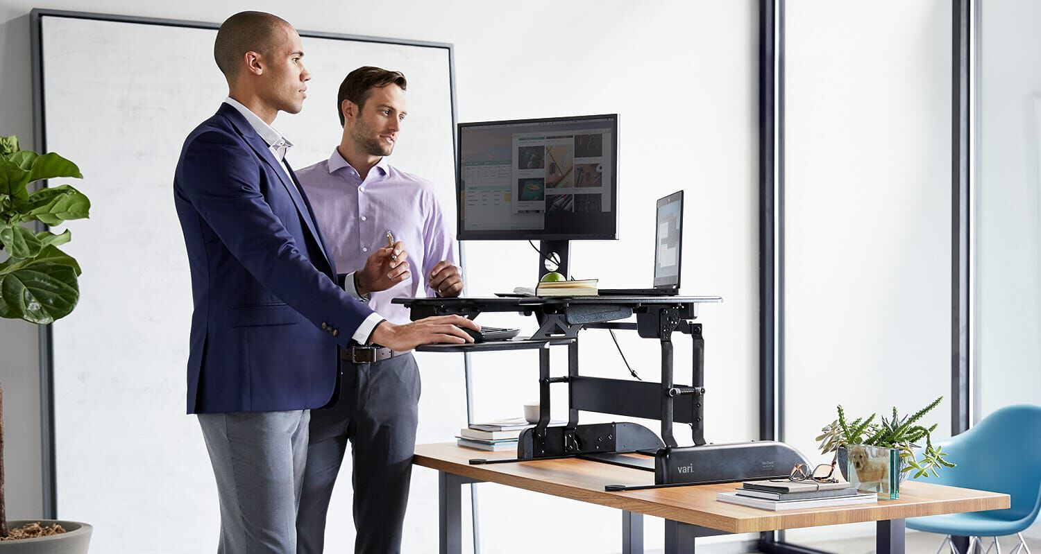 professionals working at a raised desktop converter
