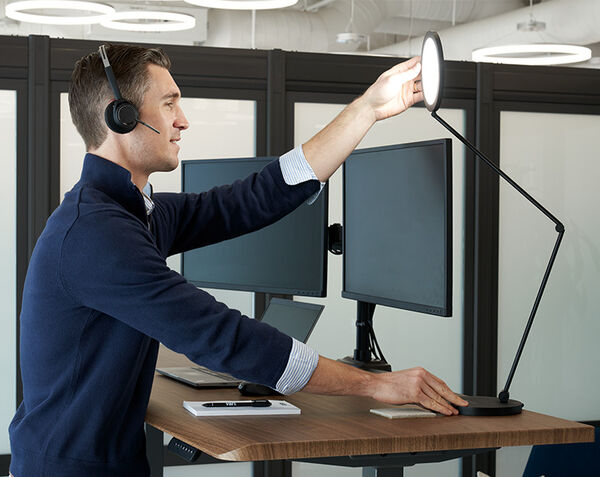 bright light temperature being used during a video call while user adjusts the top hinge to their preference