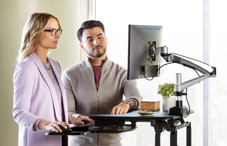 individuals working on desk converter with vari single monitor arm