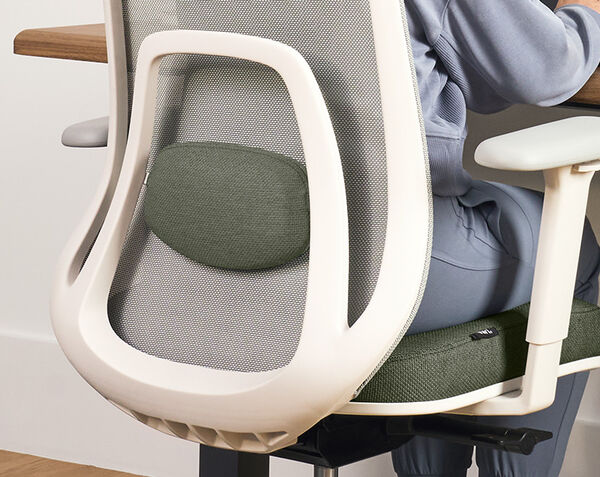 person sitting on ascent chair with closeup of lumbar support
