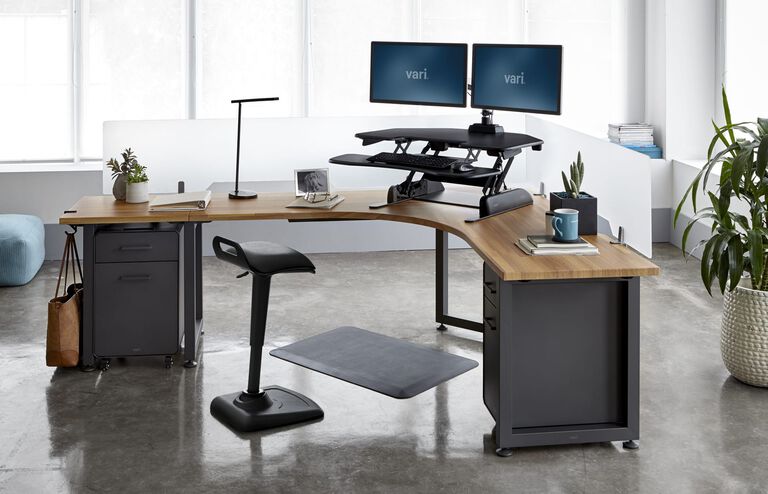 Individual working on VariDesk Cube Corner in office setting