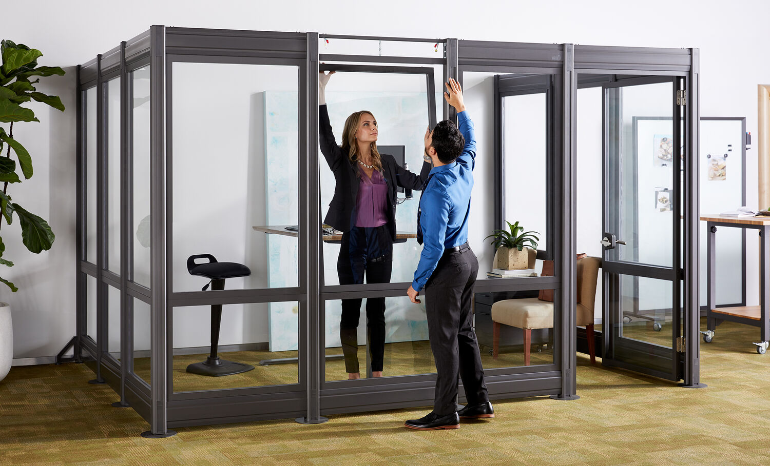 2 professionals installing quickflex walls to create private office space