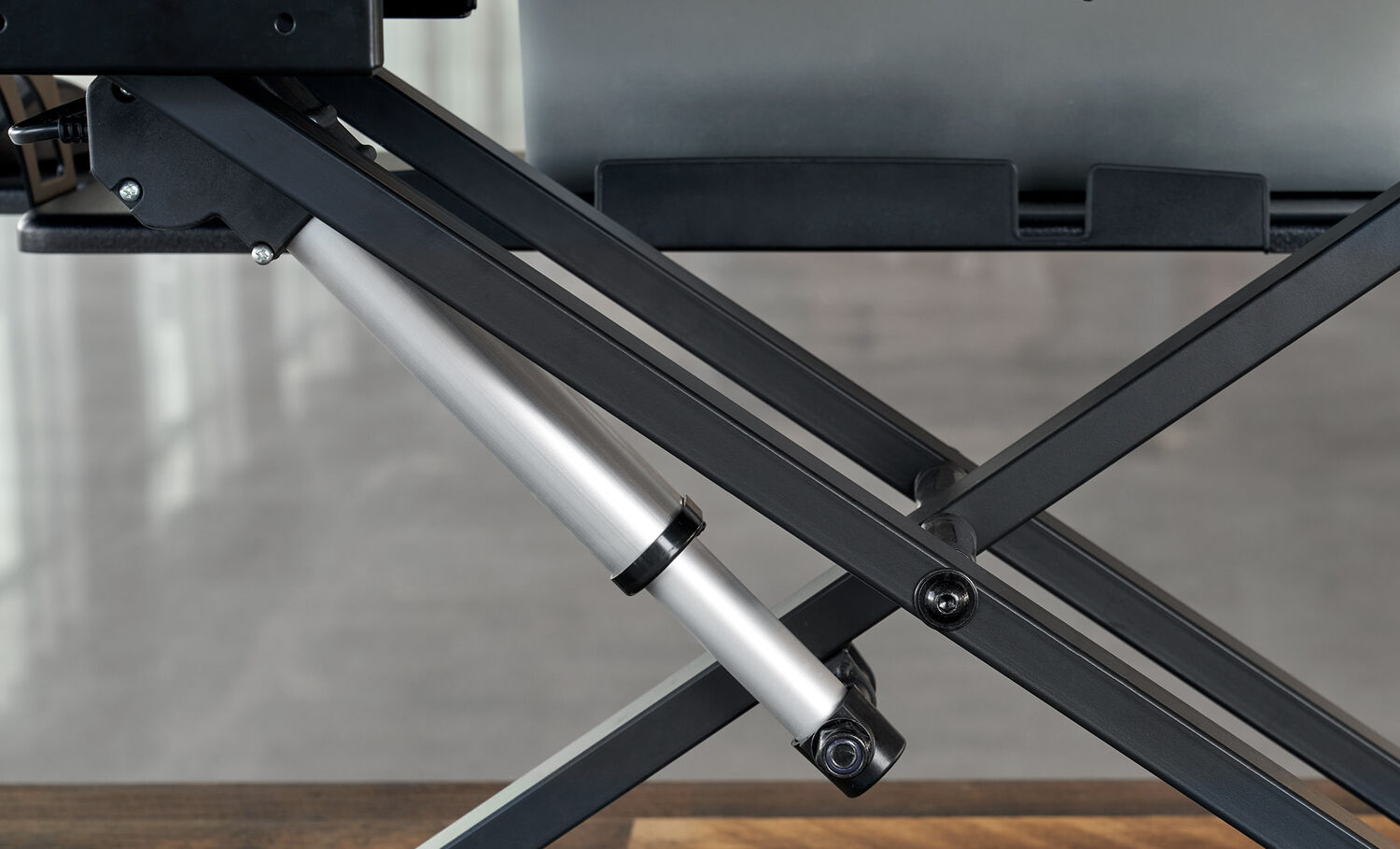 Close up view of the x frame on the electric standing desk converter