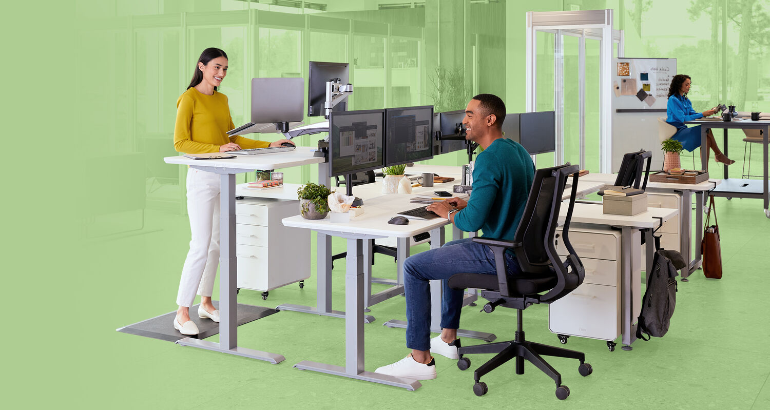 individuals working at their workspaces in an open office