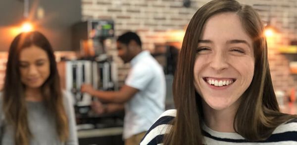 professional smiling at coffee bar