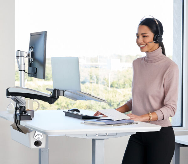 Professional standing at her desk working