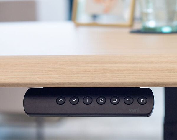 Control panel shows buttons for four programmable height settings