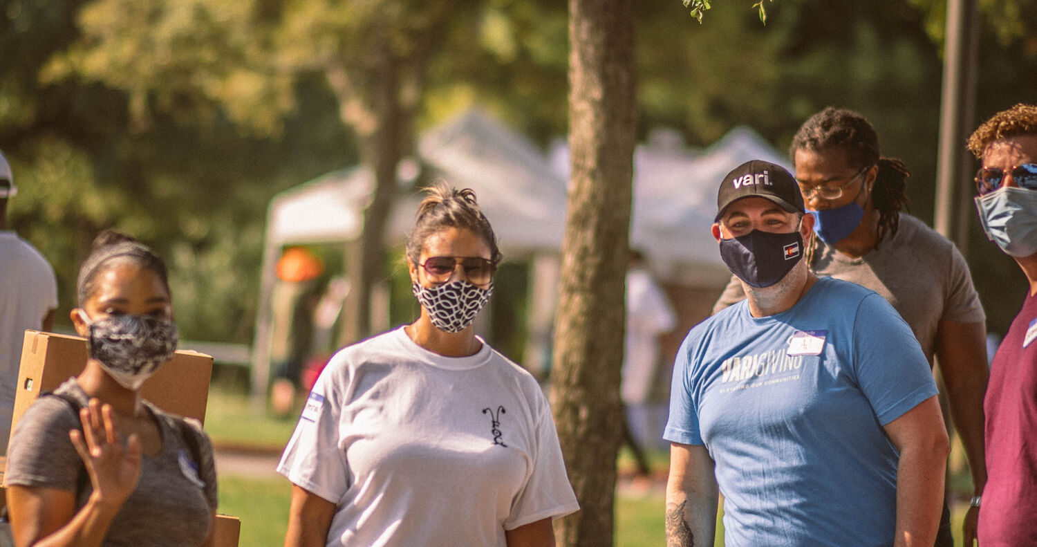 vari employees volunteering at a community giving event