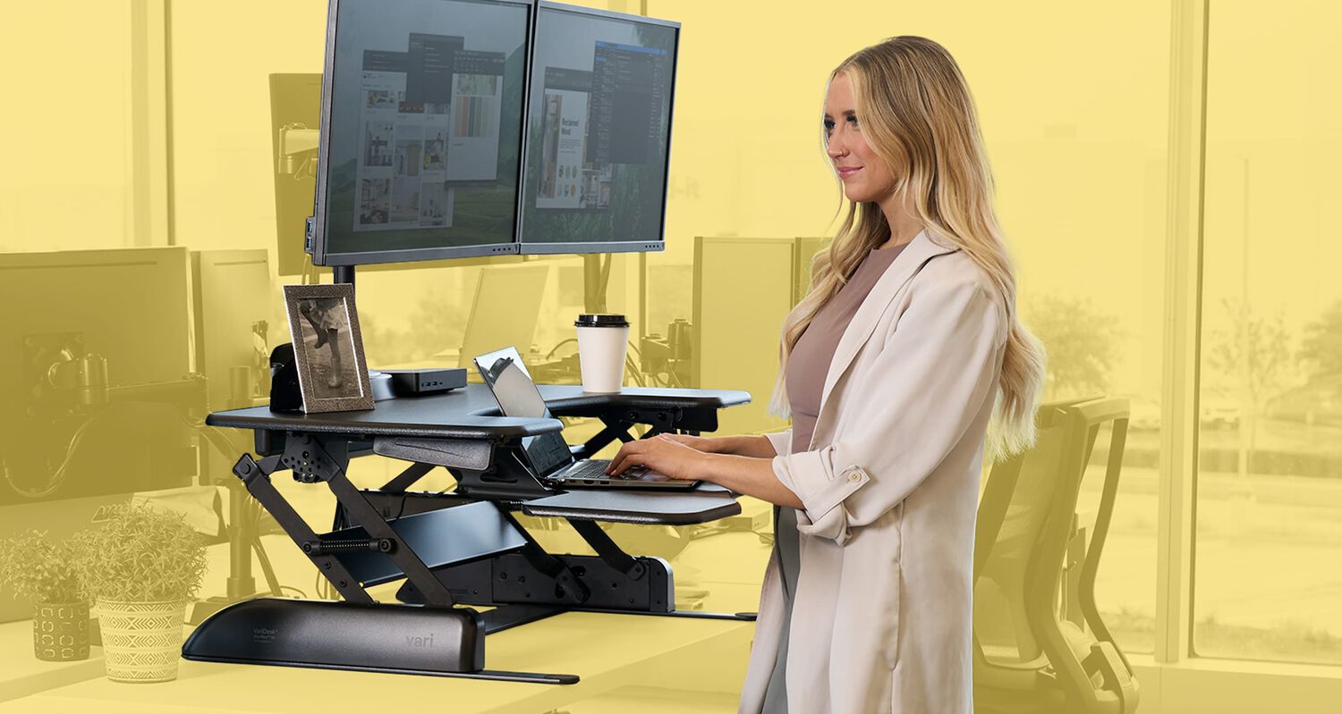 woman standing and working at a black standing converter in an office setting