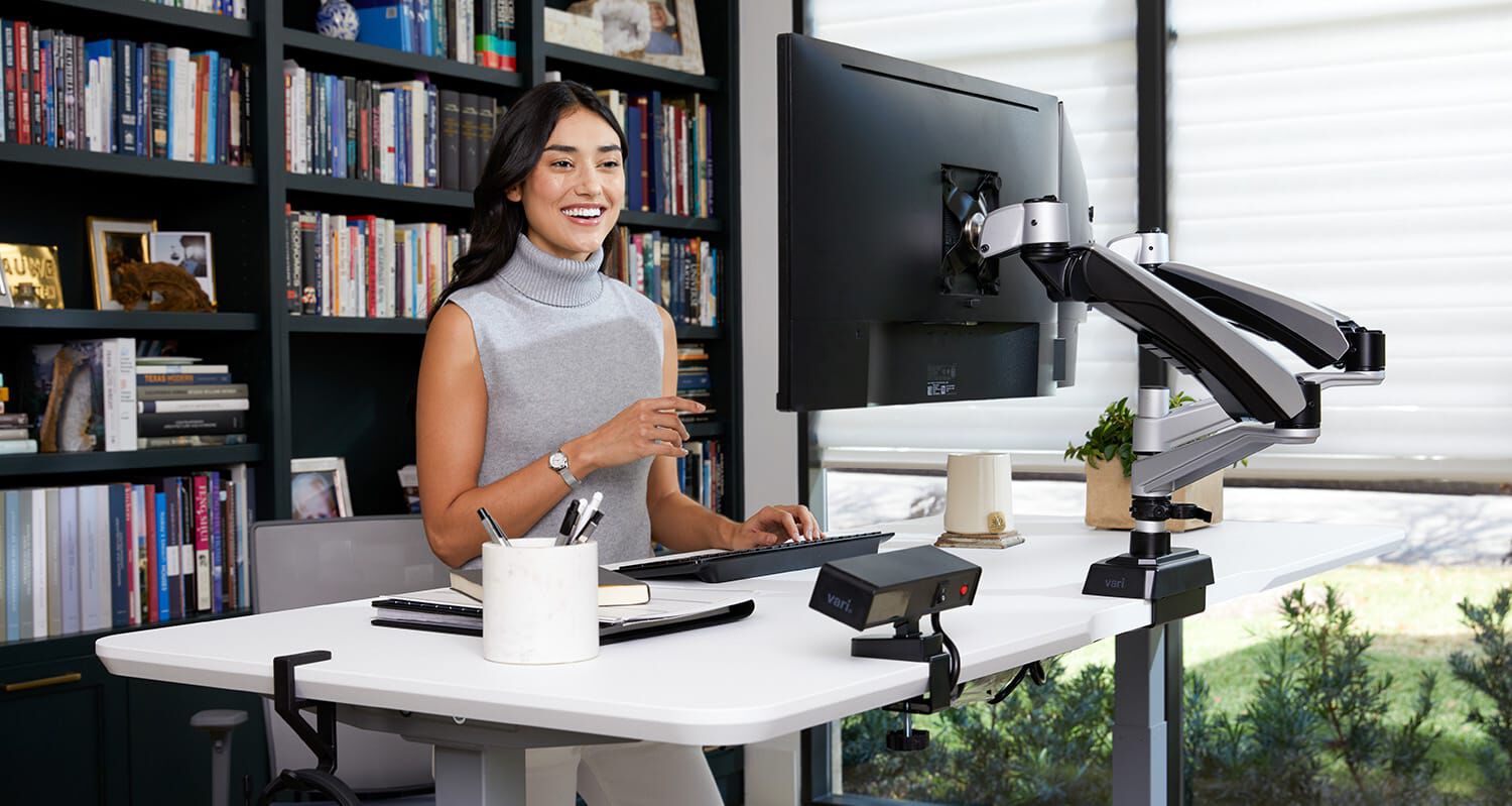 two individuals working at a desk converter in an office setting