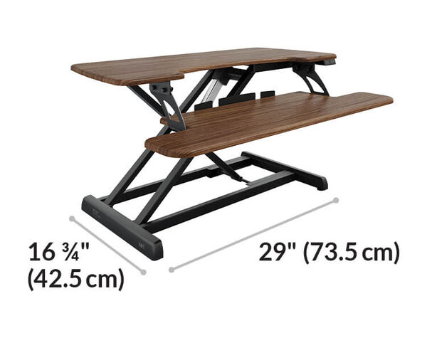 Dimension image shows that the base of the desk riser is sixteen and three quarter inches deep