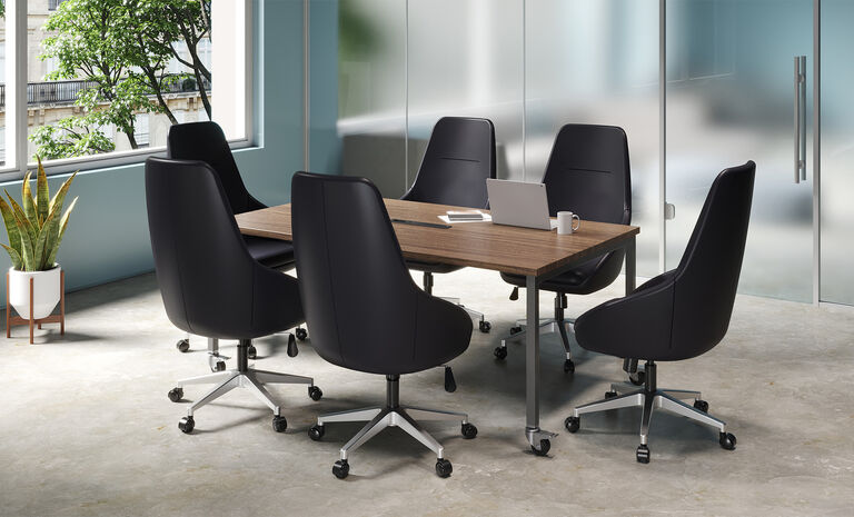 individuals in conference room with vari standing conference table