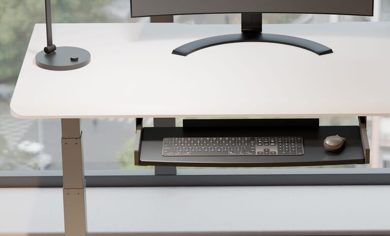 keyboard tray attached to bottom of white desk