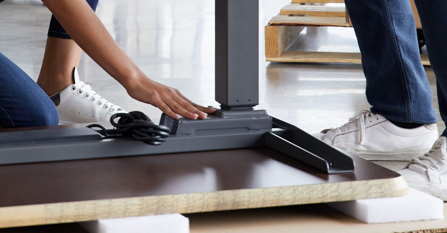 vari electric standing desk being assembled