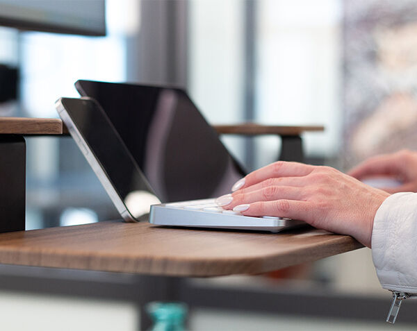 close up view of varidesk premier electric keyboard stand with a tilt for laptop monitor and phone rest