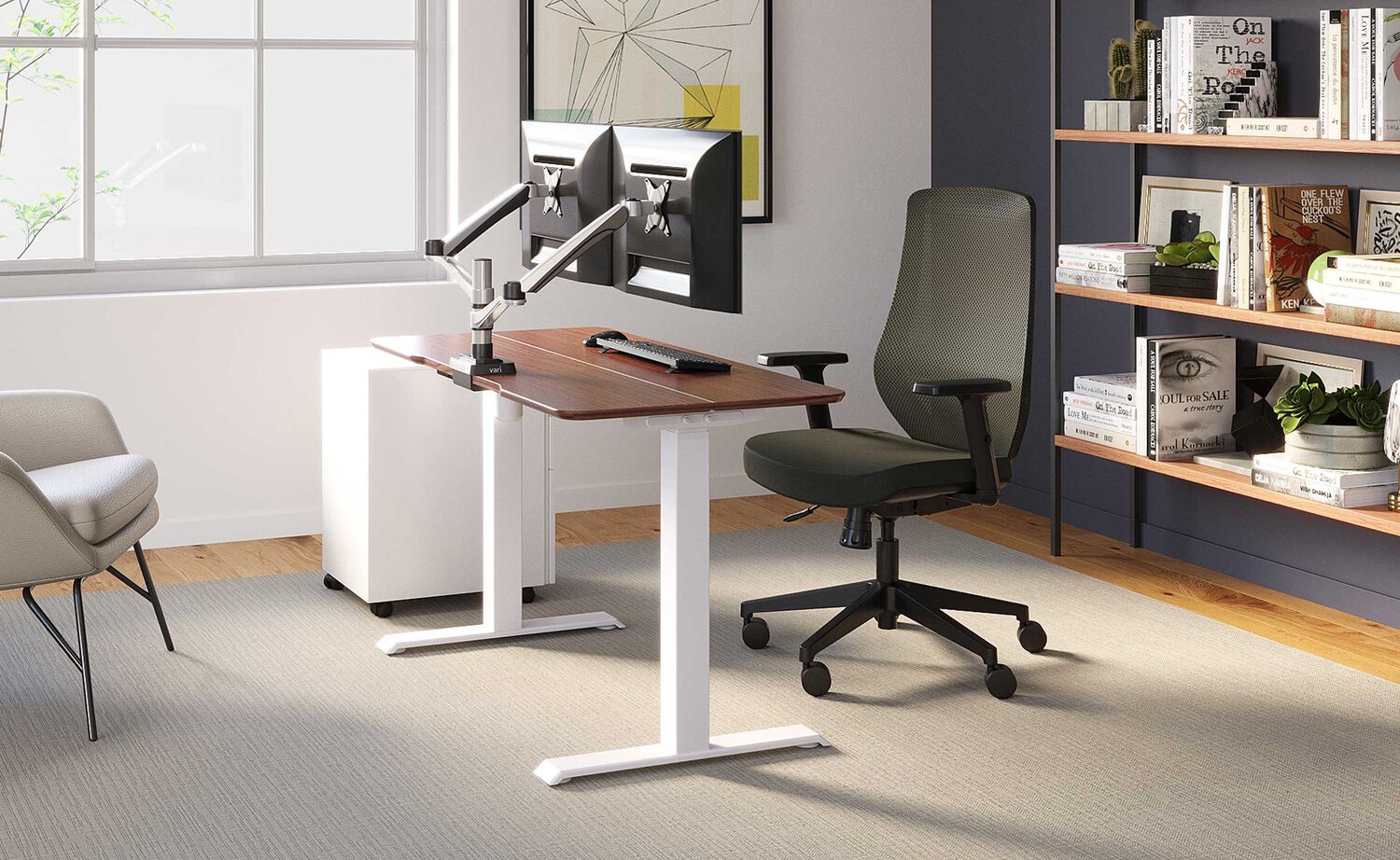 vari essential electric standing desk split top in office environment with accessories